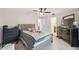 Comfortable main bedroom featuring a ceiling fan, neutral colors, and access to a private bathroom at 1700 Ironwood E Ct, Oldsmar, FL 34677