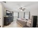 Cozy main bedroom with a ceiling fan, ample natural light, and neutral decor at 1700 Ironwood E Ct, Oldsmar, FL 34677