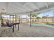 Screened pool area with pavers and a table offers a relaxing outdoor space at 1700 Ironwood E Ct, Oldsmar, FL 34677