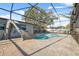 Screened-in pool with slide and paver decking offers the ultimate backyard experience at 1700 Ironwood E Ct, Oldsmar, FL 34677