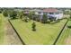Fenced-in backyard with a well-maintained lawn, playground, and mature landscaping at 17724 Daisy Farm Dr, Lutz, FL 33559
