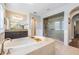 Bright bathroom features a soaking tub and a walk-in shower with a glass enclosure at 17724 Daisy Farm Dr, Lutz, FL 33559