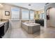 Luxurious bathroom with a large soaking tub, dual vanities, and tiled floors at 17724 Daisy Farm Dr, Lutz, FL 33559