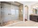 Large walk-in shower with pebble floor, glass enclosure and granite-topped vanity at 17724 Daisy Farm Dr, Lutz, FL 33559