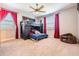 Cozy bedroom featuring a bunk bed with a dark wood frame and red curtains for a comfortable space at 17724 Daisy Farm Dr, Lutz, FL 33559
