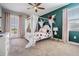 Floral bedroom with a four-poster bed, pink curtains, and natural light from the windows at 17724 Daisy Farm Dr, Lutz, FL 33559