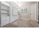 Bedroom featuring built-in shelving, drawers and cabinets. Interior door and beach painting at 17724 Daisy Farm Dr, Lutz, FL 33559