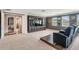 Large bonus room with built-in entertainment center, comfortable seating, and carpeted floors, perfect for movie nights at 17724 Daisy Farm Dr, Lutz, FL 33559