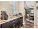 Butler Pantry features granite countertops, mosaic tile backsplash, dark cabinetry, and storage at 17724 Daisy Farm Dr, Lutz, FL 33559