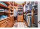 Walk-in closet with wood shelving and hanging rods and space for organizing apparel at 17724 Daisy Farm Dr, Lutz, FL 33559