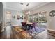 Bright dining room with wood floors, colorful rug, and sliding glass doors to outdoor pool area at 17724 Daisy Farm Dr, Lutz, FL 33559