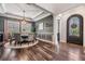 Elegant dining room featuring hardwood floors, decorative moldings and modern chandelier at 17724 Daisy Farm Dr, Lutz, FL 33559