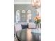 Dining room with decorative mirrors, stylish furniture, and elegant chandelier at 17724 Daisy Farm Dr, Lutz, FL 33559
