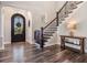 Elegant foyer with dark wood flooring, a staircase, and a decorative front door at 17724 Daisy Farm Dr, Lutz, FL 33559