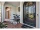 Inviting front entrance with decorative door, stone columns, and outdoor seating at 17724 Daisy Farm Dr, Lutz, FL 33559