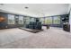 Large game room with a pool table, projector screen, and comfortable seating on a raised platform at 17724 Daisy Farm Dr, Lutz, FL 33559