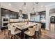 Bright kitchen boasts a large granite island, stainless steel appliances, and custom pendant lighting at 17724 Daisy Farm Dr, Lutz, FL 33559