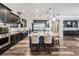 Gourmet kitchen features an oversized island with seating, stainless steel appliances, and wood-look floors at 17724 Daisy Farm Dr, Lutz, FL 33559
