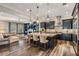 Open concept kitchen with island seating, stainless appliances, and hardwood floors at 17724 Daisy Farm Dr, Lutz, FL 33559