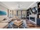 Comfortable living room with large sectional sofa, fireplace, and ample natural light from many windows at 17724 Daisy Farm Dr, Lutz, FL 33559