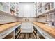Walk-in pantry with custom shelving, butcher block counters, and tile backsplash at 17724 Daisy Farm Dr, Lutz, FL 33559