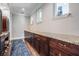 Walk-in pantry with dark wood cabinetry, granite counters, and a blue accent rug at 17724 Daisy Farm Dr, Lutz, FL 33559