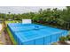 This bright blue community sports court includes tennis, basketball, and racquetball for active residents at 17724 Daisy Farm Dr, Lutz, FL 33559