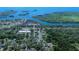 Stunning aerial view of 1820 Ruimar Ln with beautiful waterfront views and lush greenery surrounding the property at 1820 Rumar Ln, Holiday, FL 34691