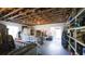 Unfinished basement featuring exposed beams and sliding glass door access to the backyard at 1820 Rumar Ln, Holiday, FL 34691