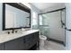 Stylish bathroom with modern fixtures, double sinks, and a glass-enclosed shower, designed for a luxurious experience at 1820 Rumar Ln, Holiday, FL 34691