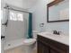 Bathroom with modern fixtures, white marble shower and vanity with warm wood accents, offering a sleek contemporary look at 1820 Rumar Ln, Holiday, FL 34691
