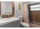 Bathroom featuring a updated vanity, toilet, and bathtub with tiled walls at 1820 Rumar Ln, Holiday, FL 34691
