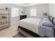 Comfortable bedroom featuring light wood floors, neutral tones, and bright windows, offering a relaxing and inviting space at 1820 Rumar Ln, Holiday, FL 34691