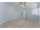 Bright bedroom with fresh paint, and a view leading to an adjacent room, providing a calm and airy feel at 1820 Rumar Ln, Holiday, FL 34691