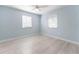This bedroom features fresh paint, updated flooring, a ceiling fan, and bright natural light at 1820 Rumar Ln, Holiday, FL 34691