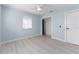 This bedroom features fresh paint, updated flooring, a ceiling fan, and a closet at 1820 Rumar Ln, Holiday, FL 34691
