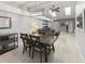 Elegant dining area with a modern light fixture, seamlessly connected to the living room for open-concept living at 1820 Rumar Ln, Holiday, FL 34691