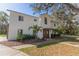 Charming two-story home with modern white siding, manicured lawn and a welcoming pergola entrance at 1820 Rumar Ln, Holiday, FL 34691