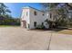 Exterior view of a charming two-story white home with a spacious driveway at 1820 Rumar Ln, Holiday, FL 34691
