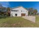 View of the home's side with grass and a garage at 1820 Rumar Ln, Holiday, FL 34691