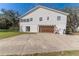 Side view of home's exterior featuring a garage with driveway and a deck at 1820 Rumar Ln, Holiday, FL 34691