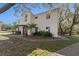 Charming two-story home with fresh paint, a well-maintained lawn, and a welcoming front entrance at 1820 Rumar Ln, Holiday, FL 34691