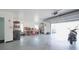 Open garage space with work bench and storage and overhead door at 1820 Rumar Ln, Holiday, FL 34691