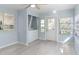 Laundry room with a stackable washer and dryer and a window looking into the kitchen at 1820 Rumar Ln, Holiday, FL 34691