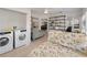 Bonus Room featuring laundry facilities, a large shelving unit, a futon, and ample natural light at 1820 Rumar Ln, Holiday, FL 34691