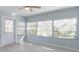 Living room with lots of natural light, fresh paint, and a door leading to the outside at 1820 Rumar Ln, Holiday, FL 34691