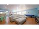 Spacious living area with an air hockey table, wet bar, and comfortable sectional sofa and ottoman at 1820 Rumar Ln, Holiday, FL 34691