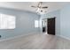 Spacious main bedroom with an ensuite bathroom, featuring light-colored walls, ample natural light and a barn door at 1820 Rumar Ln, Holiday, FL 34691