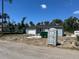 Exterior view of a light gray single-Gathering home under construction with new roof and a portable toilet at 199 Statler St, Port Charlotte, FL 33954