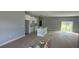 Bright, unfinished open-concept living room with large sliding glass doors and neutral paint at 199 Statler St, Port Charlotte, FL 33954
